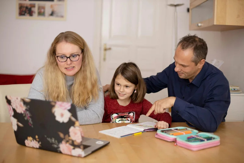 Family using technology together to research and evaluate homeschool curriculum options