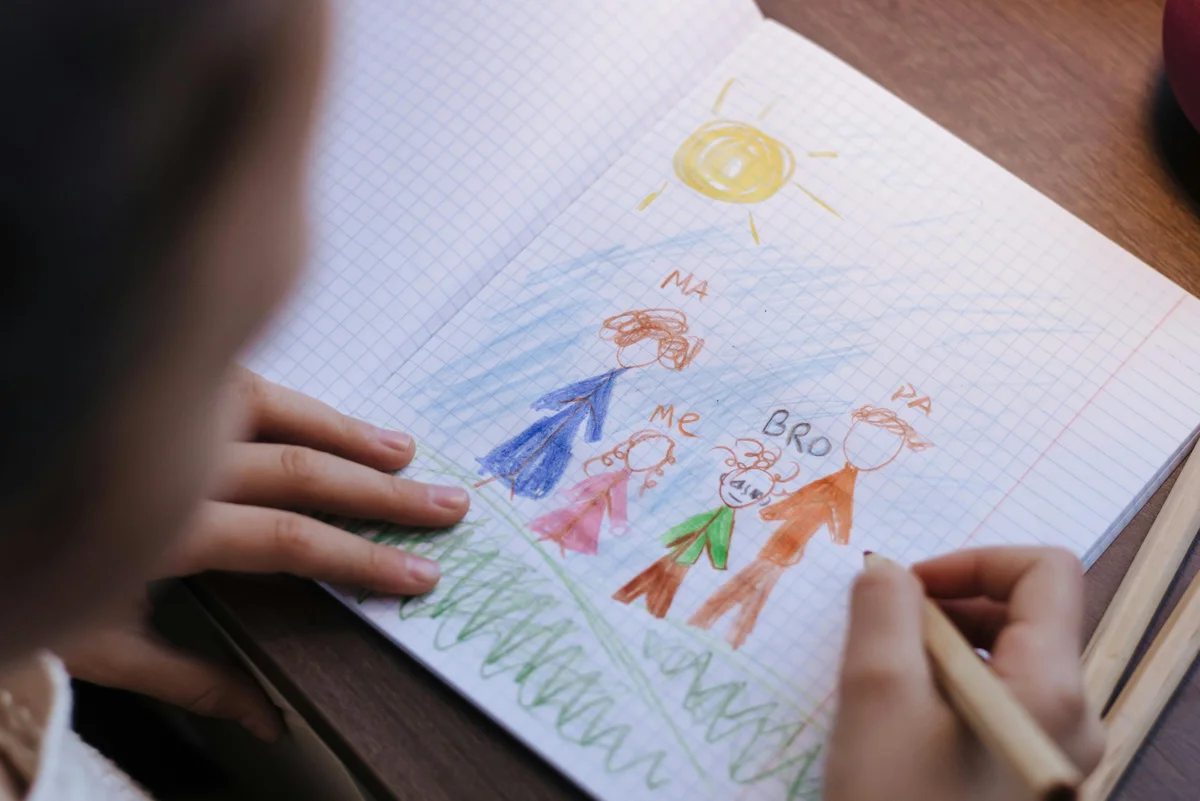 Child drawing a family portrait with crayons during Florida homeschool activities