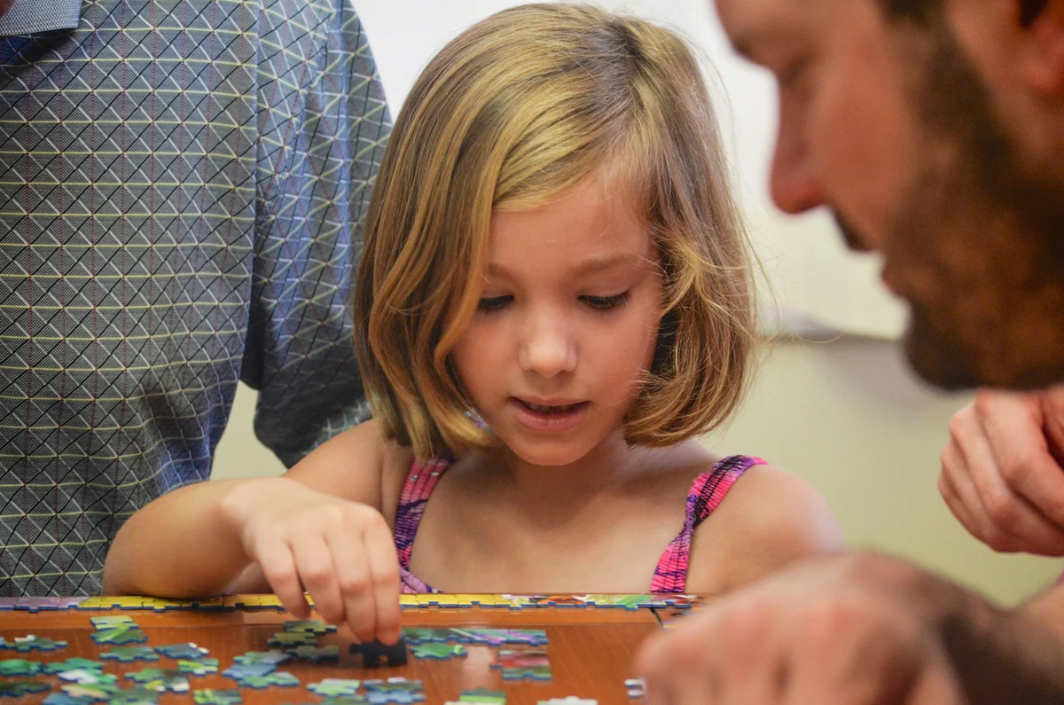 Family working on educational puzzles together during Florida homeschool session