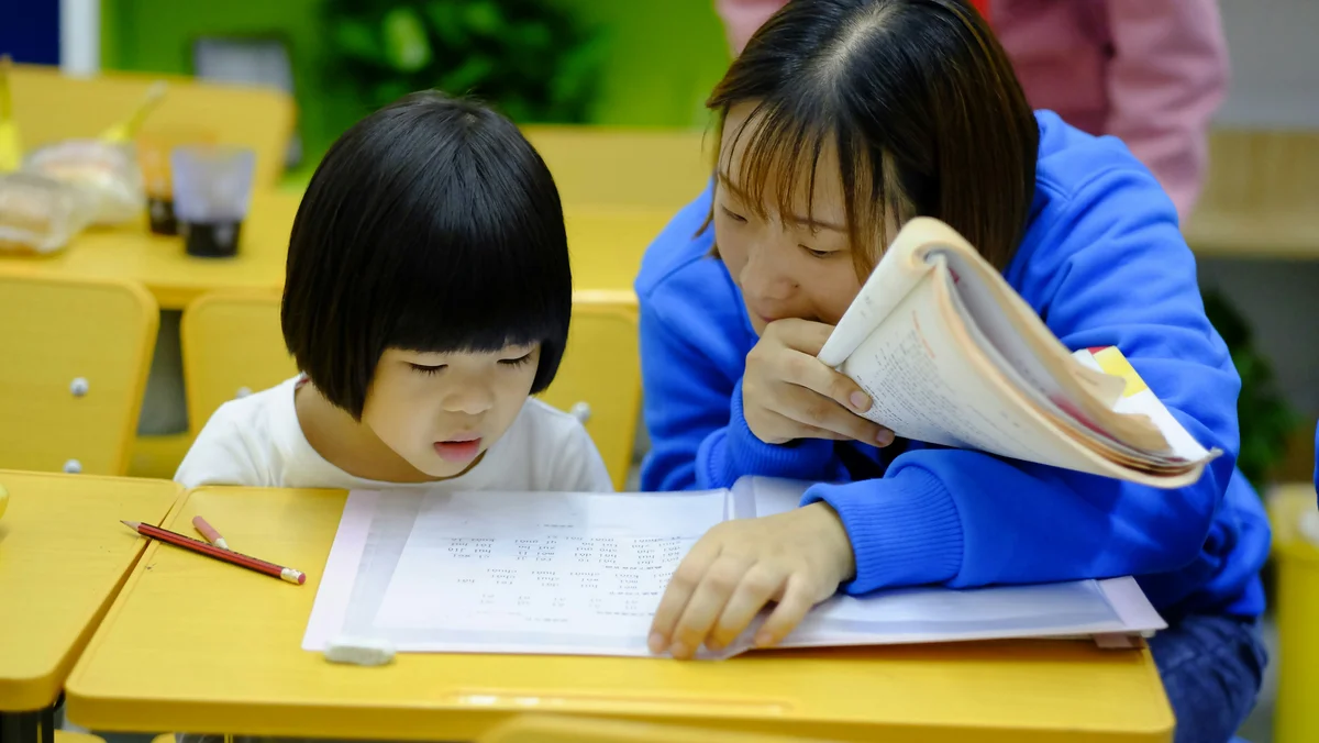 Woman teaching girl during homeschool lesson in Connecticut