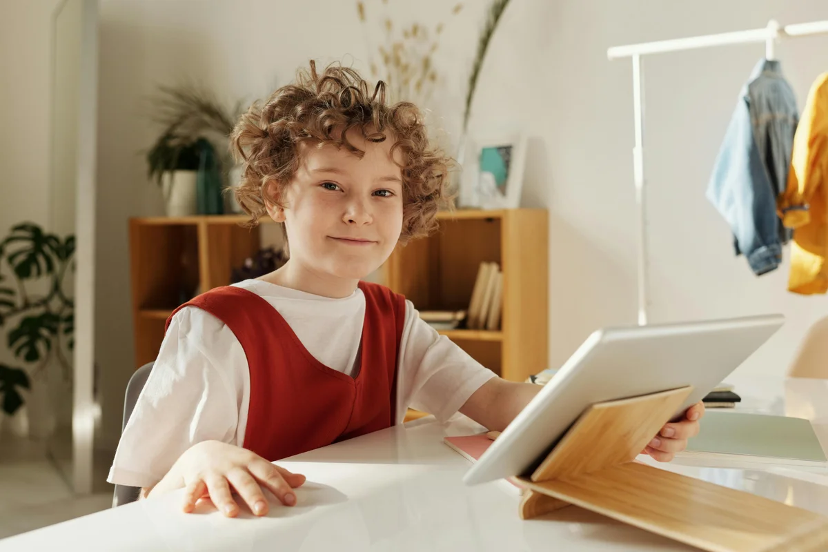 Cheerful child enjoying homeschool learning with tablet in Iowa