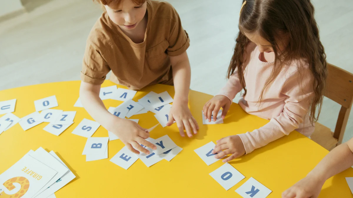 Two children learning with alphabet cards during homeschool in Utah