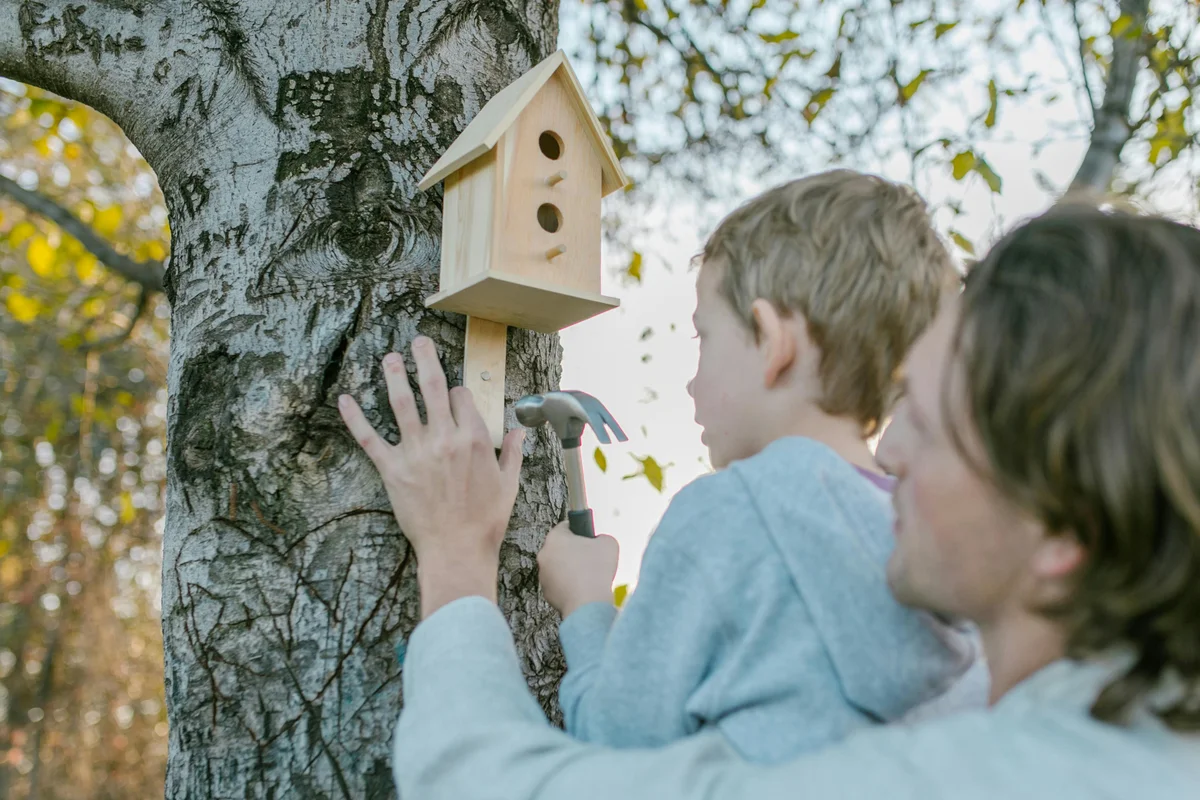 Father and son doing hands-on learning activity outdoors in Vermont