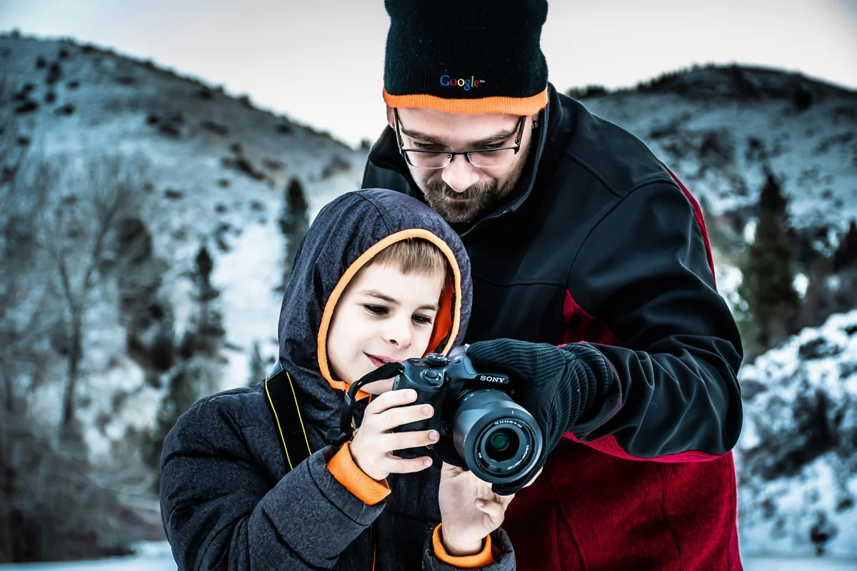 Father teaching son outdoors in Wyoming - homeschool education in nature