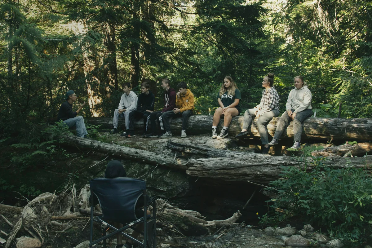 Family learning outdoors in Idaho forest - homeschool nature education
