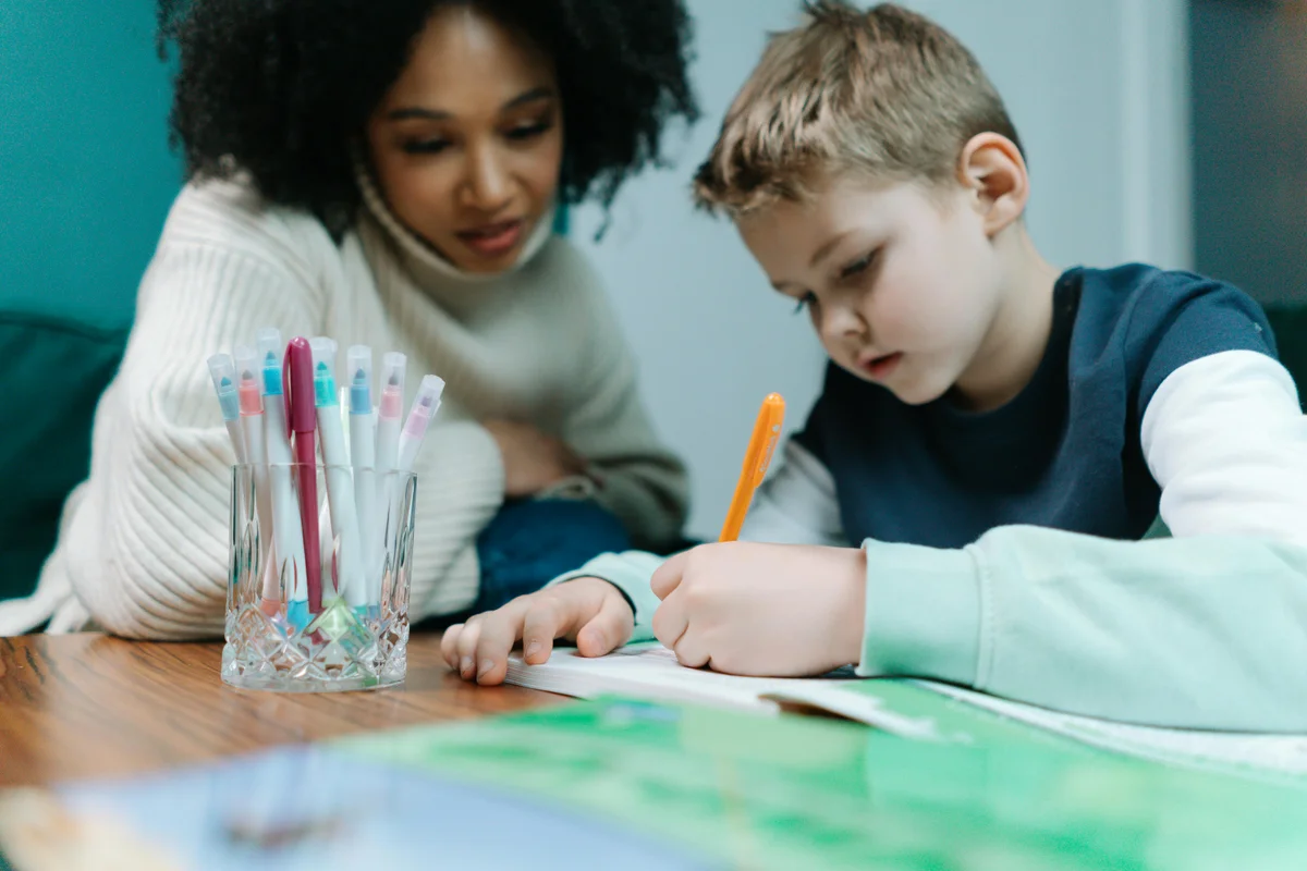Child writing in notebook during homeschool lesson in Illinois