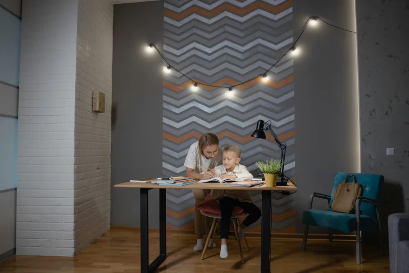 Mother helping son with reading lesson in homeschool setting