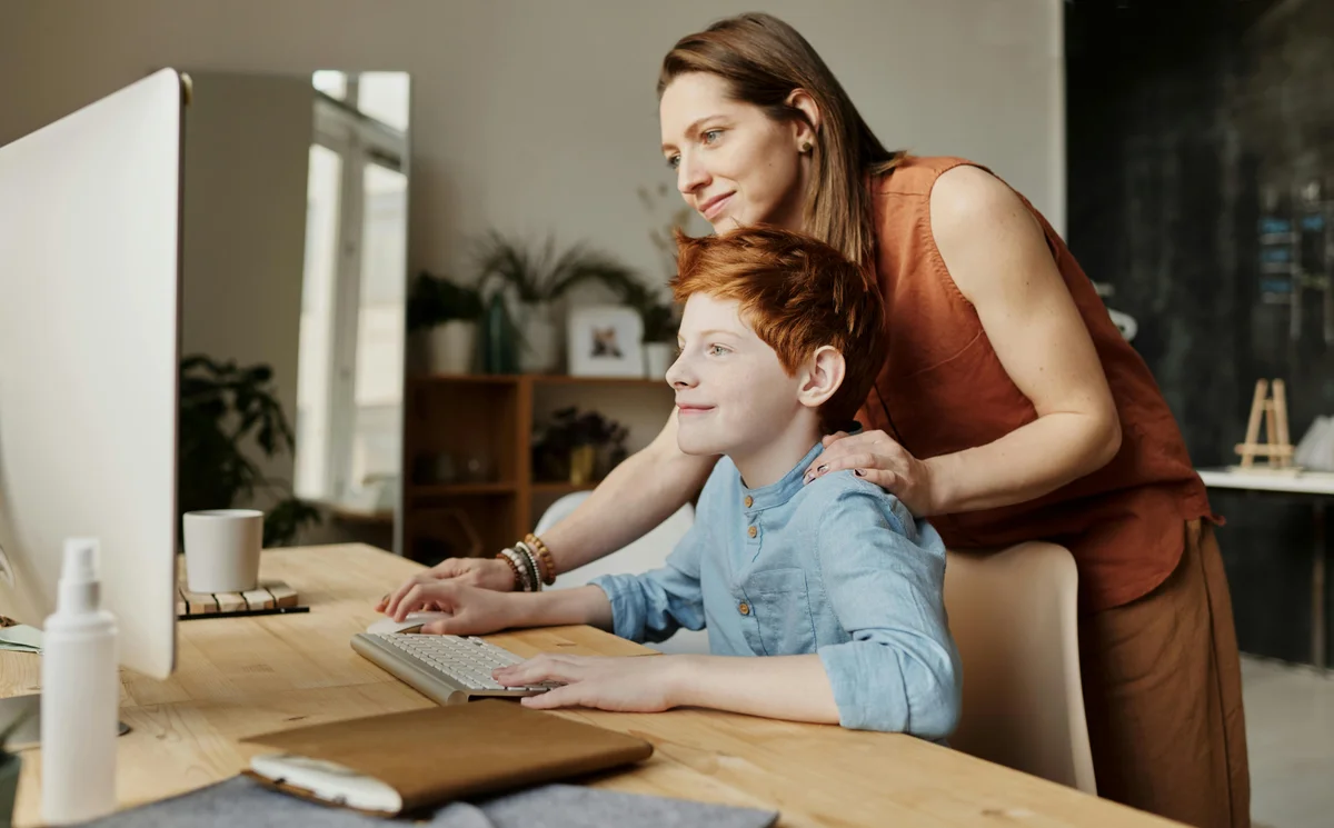 Mother and child using computer for homeschool in North Dakota