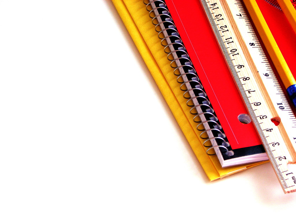 Student working on writing assignment with notebook and pencil