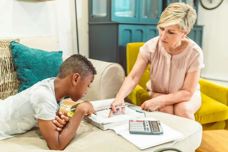 Mother reading aloud to child on couch - Charlotte Mason living books approach